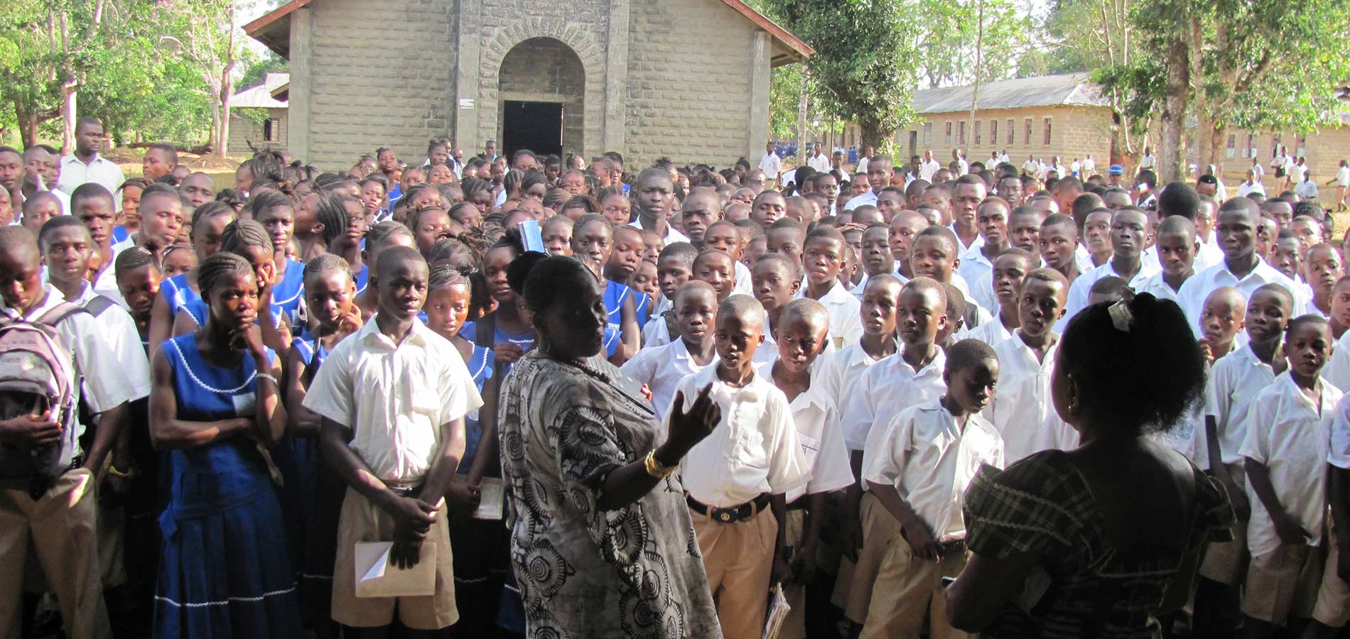 Students assembled in front of the chapel now have clean water to drink and lighting to study at night