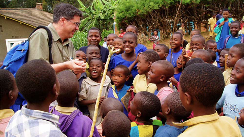 Bernard Amadei with children in the field